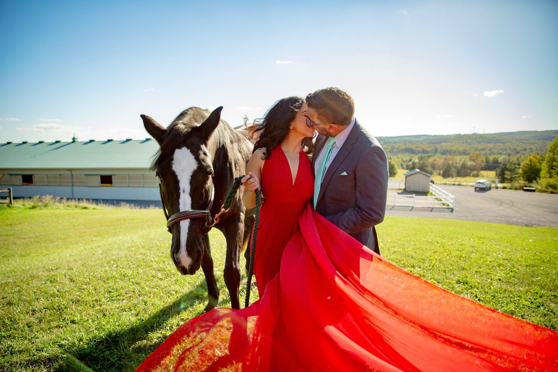 Couple with horse, bride in red gown