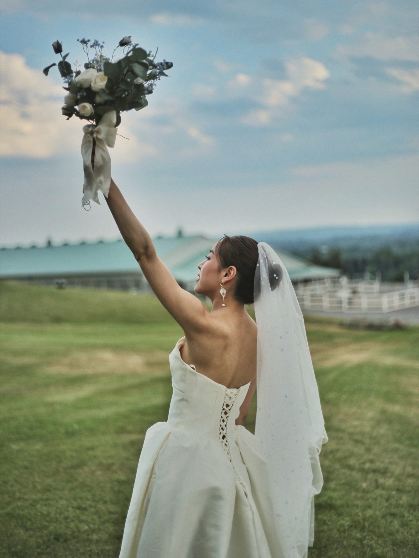 Bride on the hill overlooking the riding arena