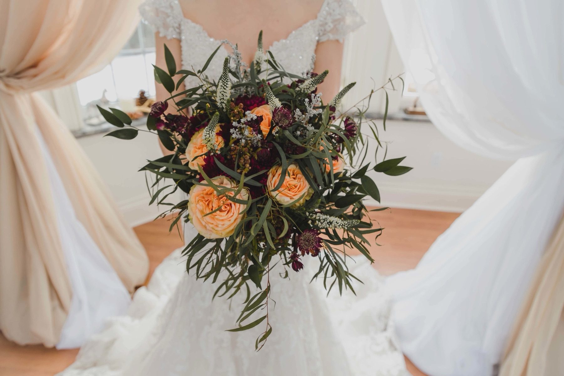 Bouquet held against a lace gown