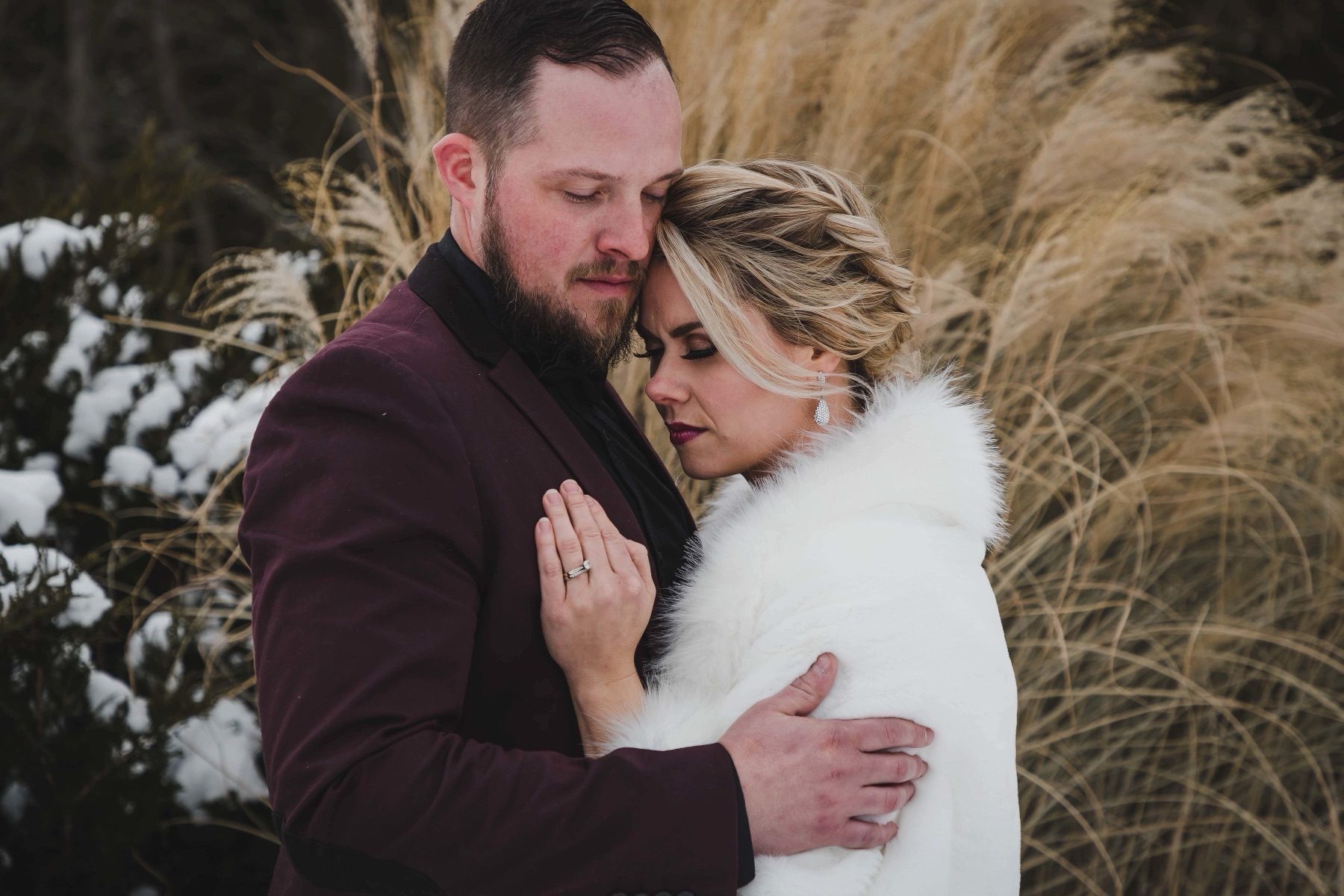 Couple embracing in tall winter grass