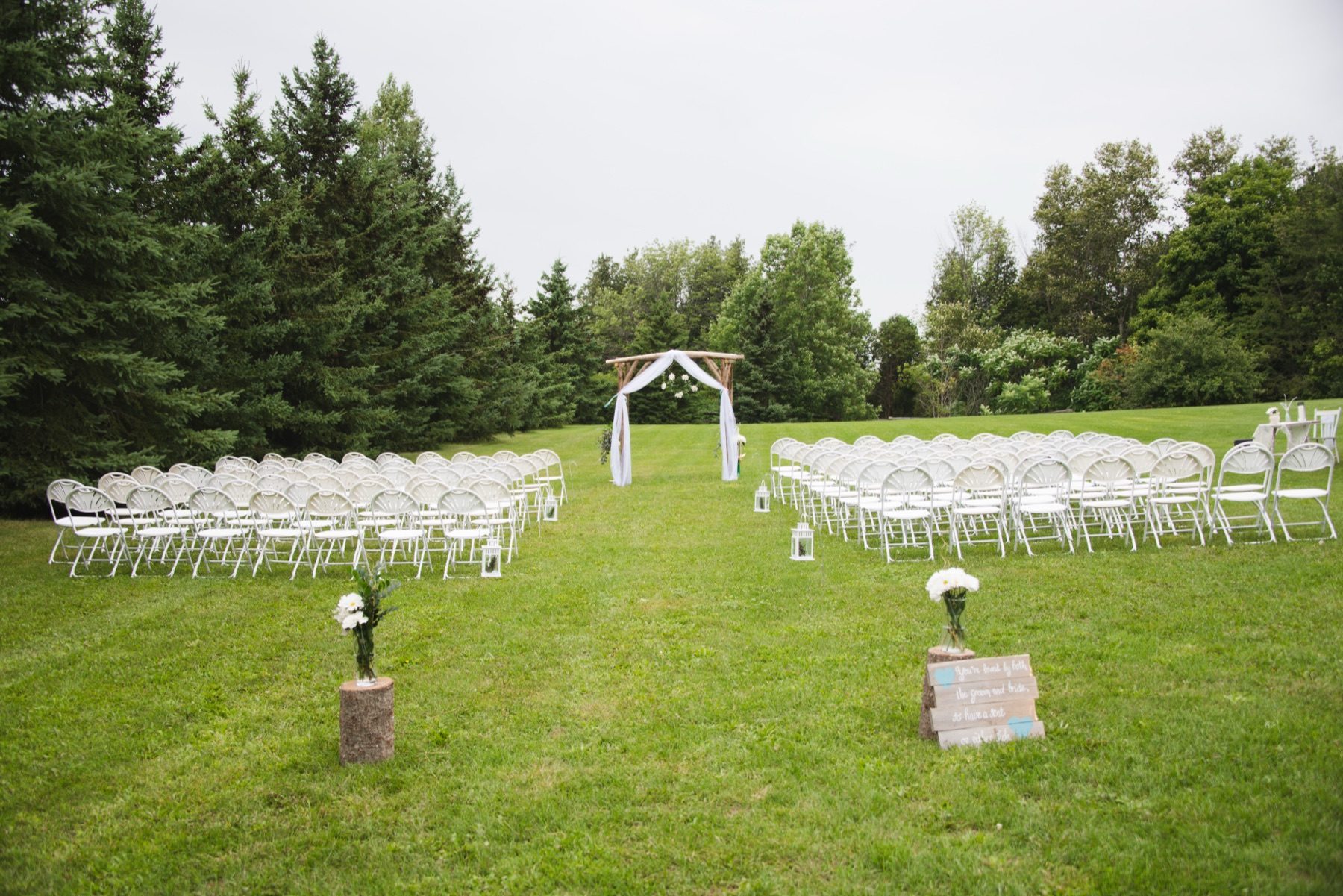 Outdoor wooden arch ceremony on the lawn