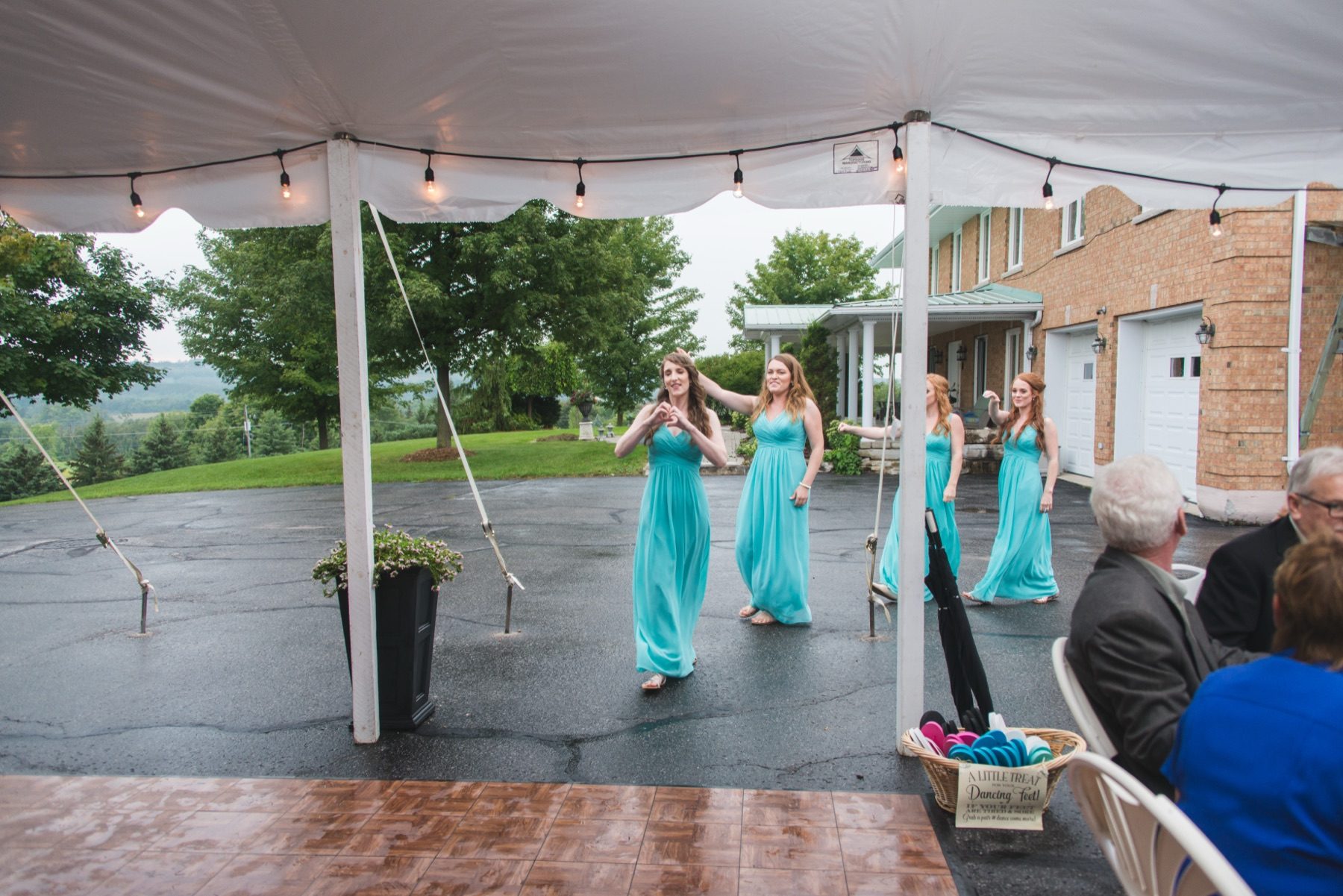 Bridesmaids dancing under the reception tent