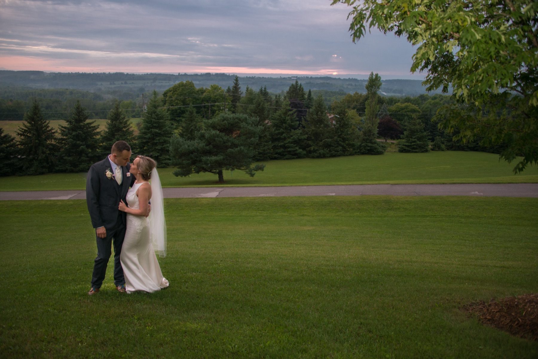 Couple standing together on the lawn at dusk