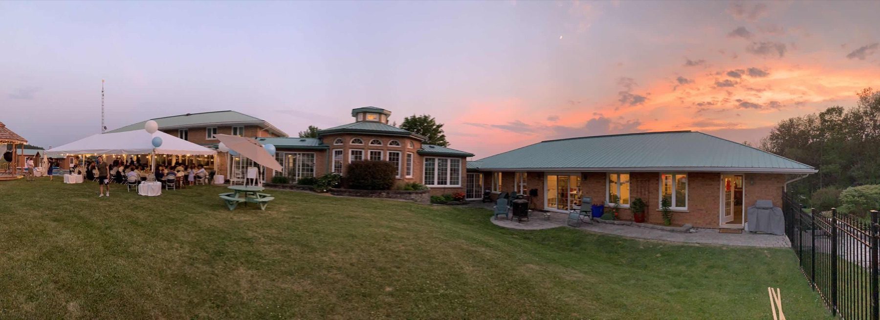Wide view of the property at sunset with reception tent