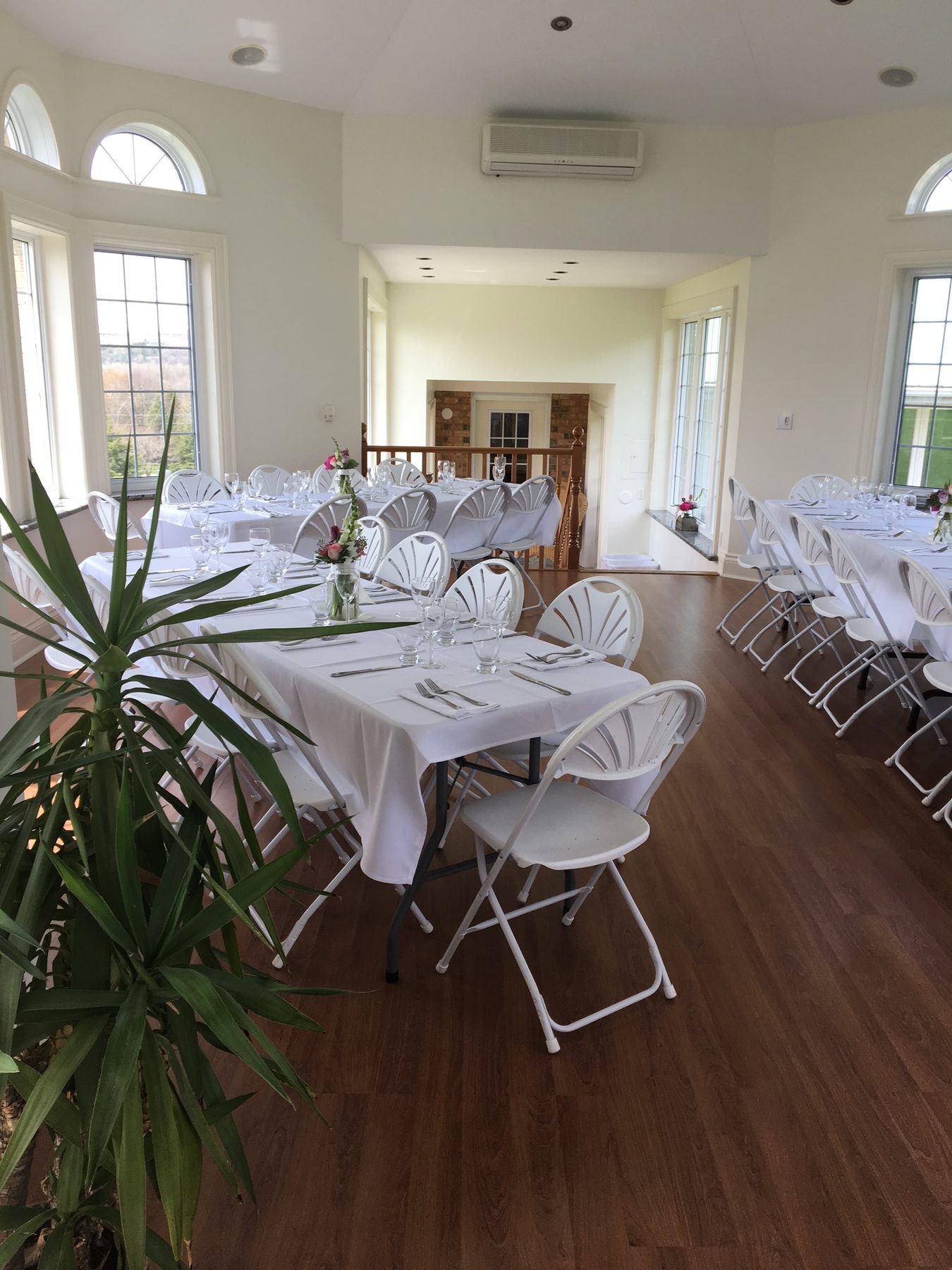 Atrium reception detail — table settings and décor